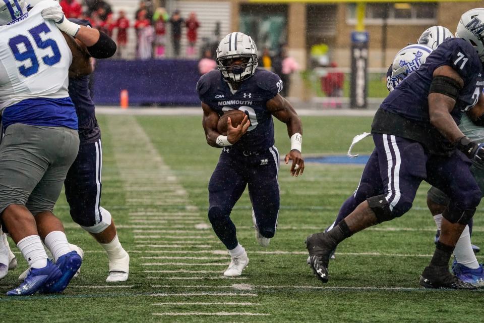 Monmouth's Jaden Shirden runs through a hole against Hampton, rushing for 276 yards and four touchdowns in Monmouth's 61-10 win in West Long Branch on Oct. 14, 2023.