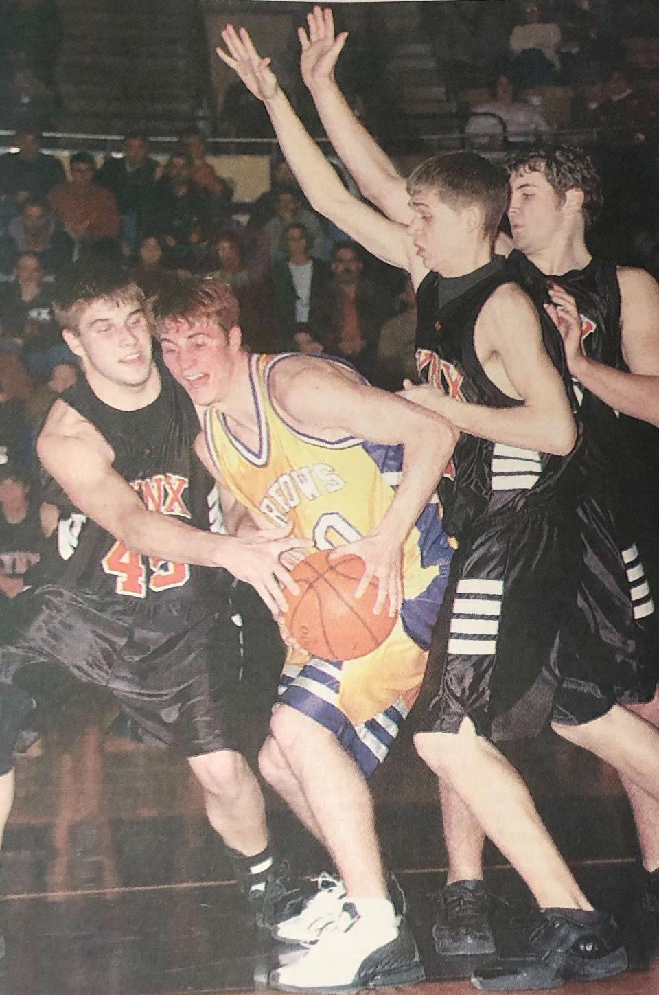 Watertown's Ryan Berry is surrounded by Brandon Valley players Justin Ossefoort (left), Josh Herr and Nick Bentle during their 2003 Region 1AA boys basketball game at Brandon.