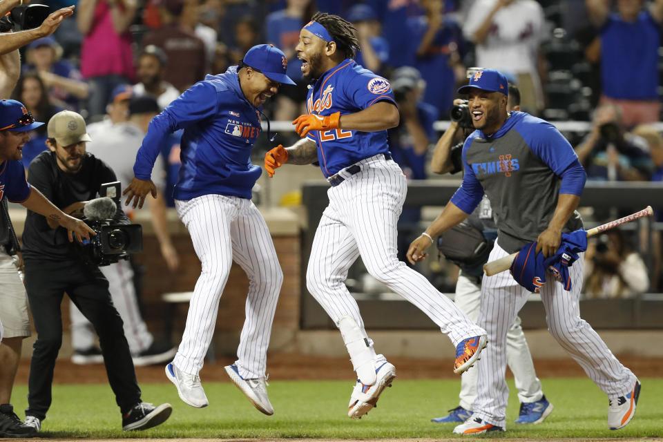 CORRECTS TO THREE-RUN HOME RUN NOT SOLO New York Mets' Marcus Stroman, left, leaps with Dominic Smith (22) as Robinson Cano watches after Smith hit a walk-off three-run home run in a baseball game against the Atlanta Braves, Sunday, Sept. 29, 2019, in New York. (AP Photo/Kathy Willens)