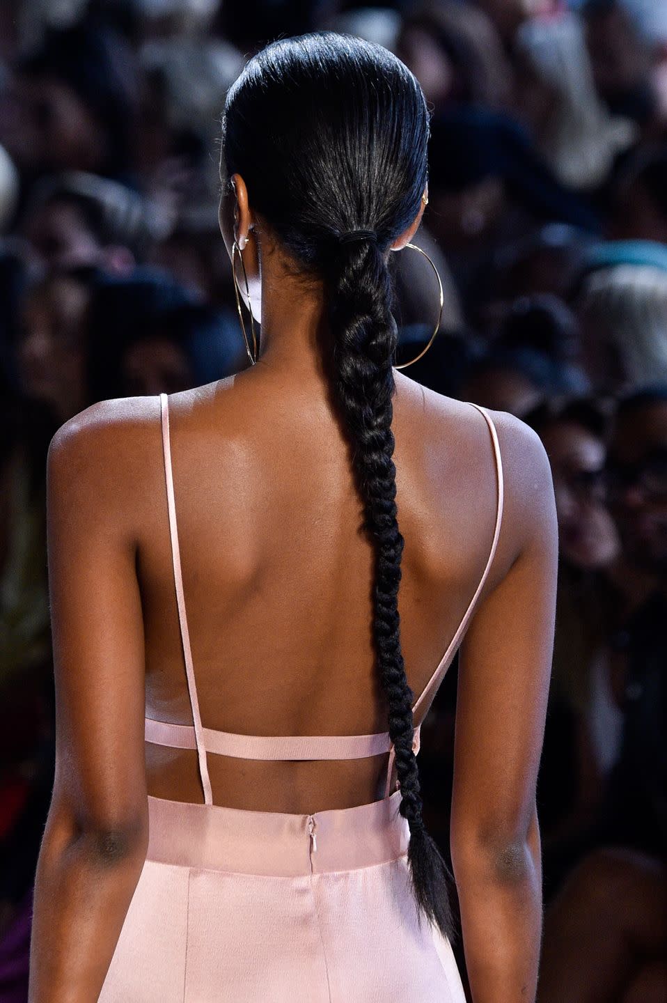 <p>Oversized hoop earrings called for a sleek and shiny braid at Cushnie's spring 2019 show.</p>