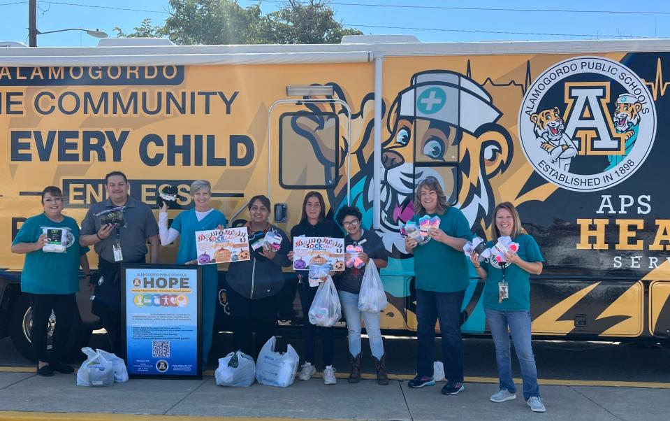 McDonalds team and Alamogordo Public Schools with donation of socks from McDonalds, Community Engagement Fund.