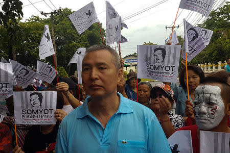 Somyot Prueksakasemsuk, 56, a high-profile Thai activist and former magazine editor jailed for insulting the country's monarchy, stands next to his supporters after his release from a Bangkok prison in Thailand, April 30, 2018. REUTERS/Aukkarapon Niyomat