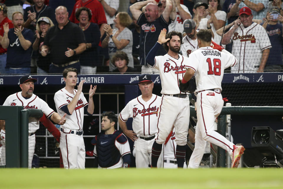 Atlanta Braves' Dansby Swanson congratulates Vaughn Grissom (18), who scored against the New York Mets during the seventh inning of a baseball game Thursday, Aug. 18, 2022, in Atlanta. (AP Photo/Brett Davis)