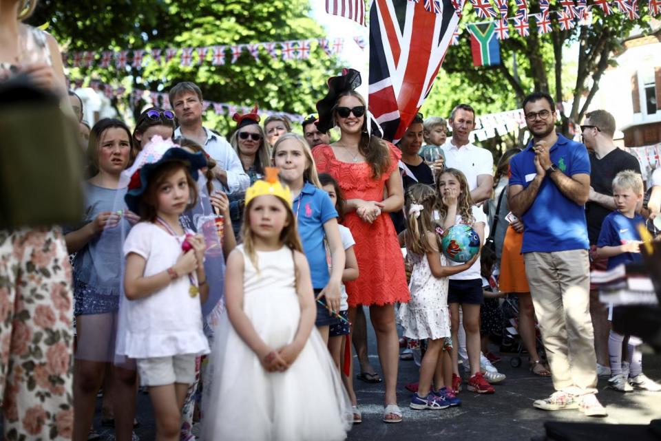 Crowds mark the occasion among Union flags at an outdoor celebration in Wandsworth (Reuters)