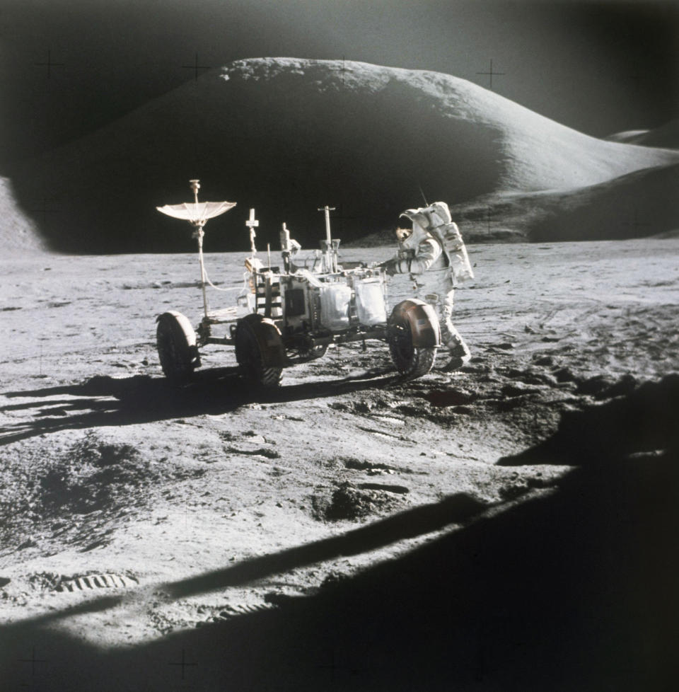 FILE - In this 1971 photo made available by NASA, astronaut James Irwin stands next to a rover on the surface of the moon. On Wednesday, May 26, 2021, Lockheed Martin and General Motors announced that they would combine their technological and manufacturing expertise to build the electric vehicles for NASA’s Artemis program, named after the twin sister of Apollo in Greek mythology. (NASA via AP, File)