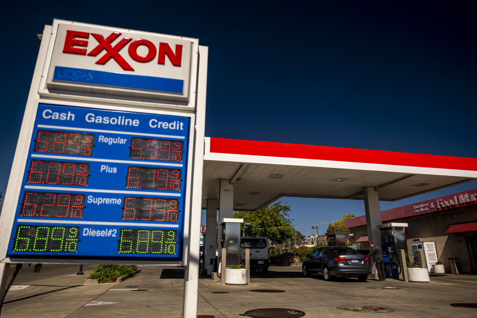 A sign shows high prices at a gas station