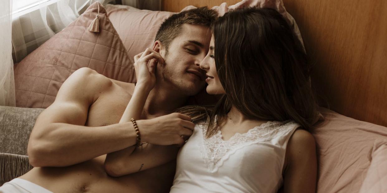intimate young couple lying in bed