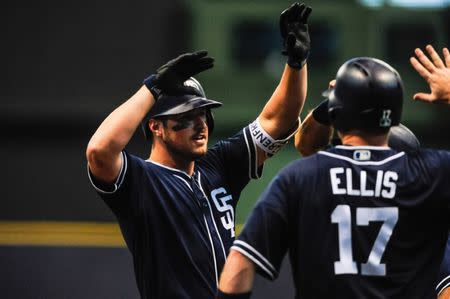 Aug 9, 2018; Milwaukee, WI, USA; San Diego Padres left fielder Hunter Renfroe (10) reacts with catcher A.J. Ellis (17) and teammates after hitting a grand slam home run during the ninth inning against the Milwaukee Brewers at Miller Park. Mandatory Credit: Jeffrey Becker-USA TODAY Sports