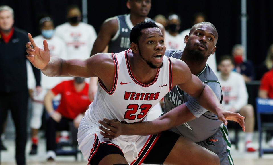 Mar 12, 2021; Frisco, Texas, USA; Western Kentucky Hilltoppers center Charles Bassey (23) is guarded by UAB Blazers forward Simeon Kirkland (10) during the second half at Ford Center at The Star. Mandatory Credit: Tim Heitman-USA TODAY Sports ORG XMIT: IMAGN-447011 ORIG FILE ID:  20210312_neb_sh2_045.JPG