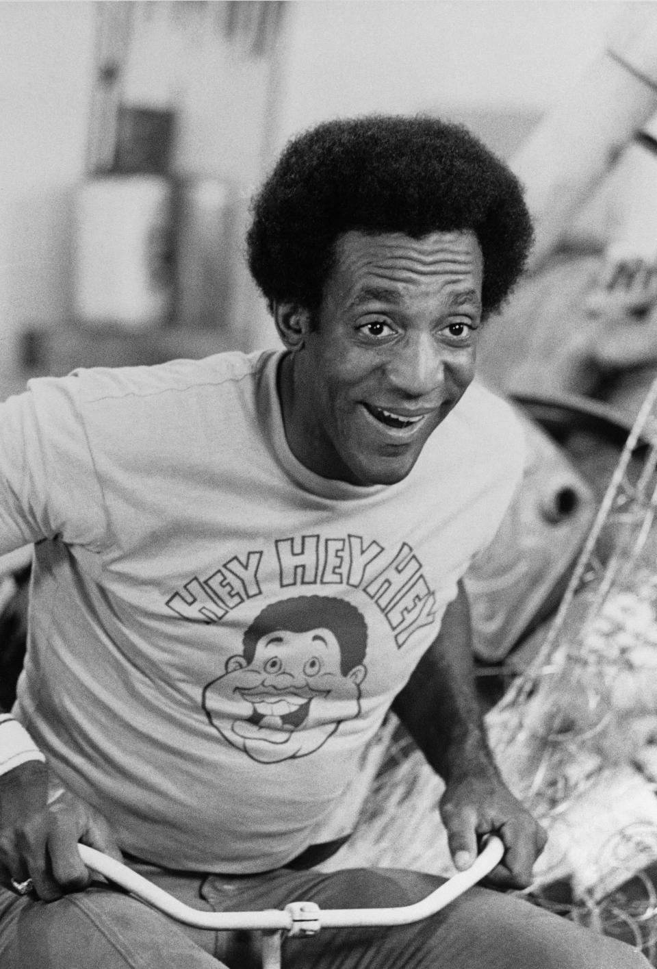 FILE – In this August 1972 file photo, Bill Cosby rides a tricycle while wearing a T-shirt depicting the cartoon character Fat Albert and the character's "Hey Hey Hey" catchphrase, as he promotes the premiere of the Saturday morning children's show "Fat Albert and the Cosby Kids." Cosby is facing the start of a sentencing hearing on Monday, Sept. 24, 2018, at which a judge will decide how to punish the 81-year-old comedian who was convicted in April of drugging and sexually assaulting former Temple University athletics employee Andrea Constand at his suburban Philadelphia home in 2004. (AP Photo, File)