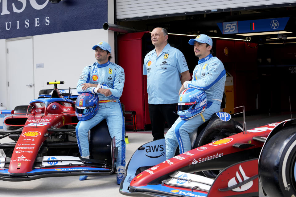 Ferrari driver Carlos Sainz, of Spain, left, Ferrari team principal Fred Vasseur, center, and Ferrari driver Charles Leclerc, of Monaco, pose for a photograph in recognition of Ferrari's partnership with HP, ahead of the Miami Formula One Grand Prix, Thursday, May 2, 2024, in Miami Gardens, Fla. (AP Photo/Lynne Sladky)