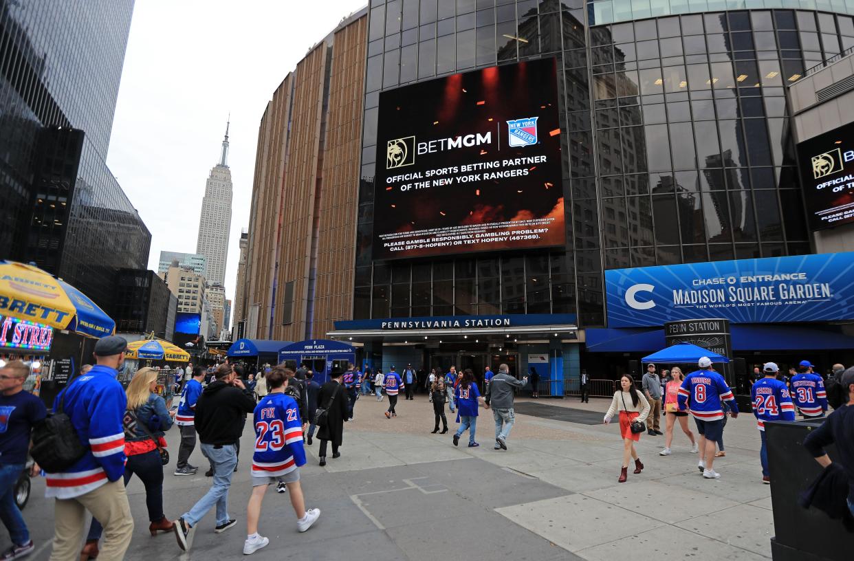 The Empire State Building is seen in the distance as New York Rangers fans walk into Madison Square Garden before a game during the 2022 Stanley Cup Playoffs. Mandatory Credit: Danny Wild-USA TODAY Sports