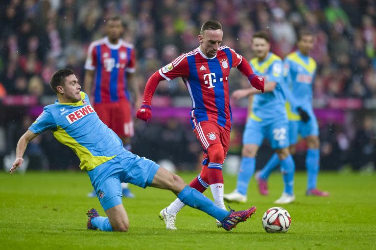 Cologne's Polish defender Pawel Olkowski (L) and Bayern Munich's French midfielder Franck Ribery vie for the ball during their German first division Bundesliga football match in Munich, Germany, on February 27, 2015