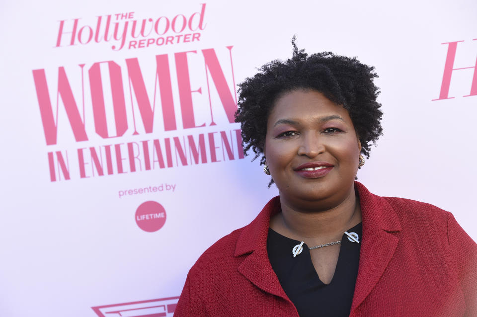 FILE - Stacey Abrams arrives at The Hollywood Reporter's Women in Entertainment Breakfast Gala in Los Angeles on Dec. 11, 2019. Berkley announced Tuesday that it had acquired rights to three out-of-print novels by Abrams that she had written nearly 20 years ago under the name Selena Montgomery. Berkley, a Penguin Random House imprint, will begin reissuing the books; “Rules of Engagement,” “The Art of Desire” and “Power of Persuasion," in 2022. (Photo by Jordan Strauss/Invision/AP, File)