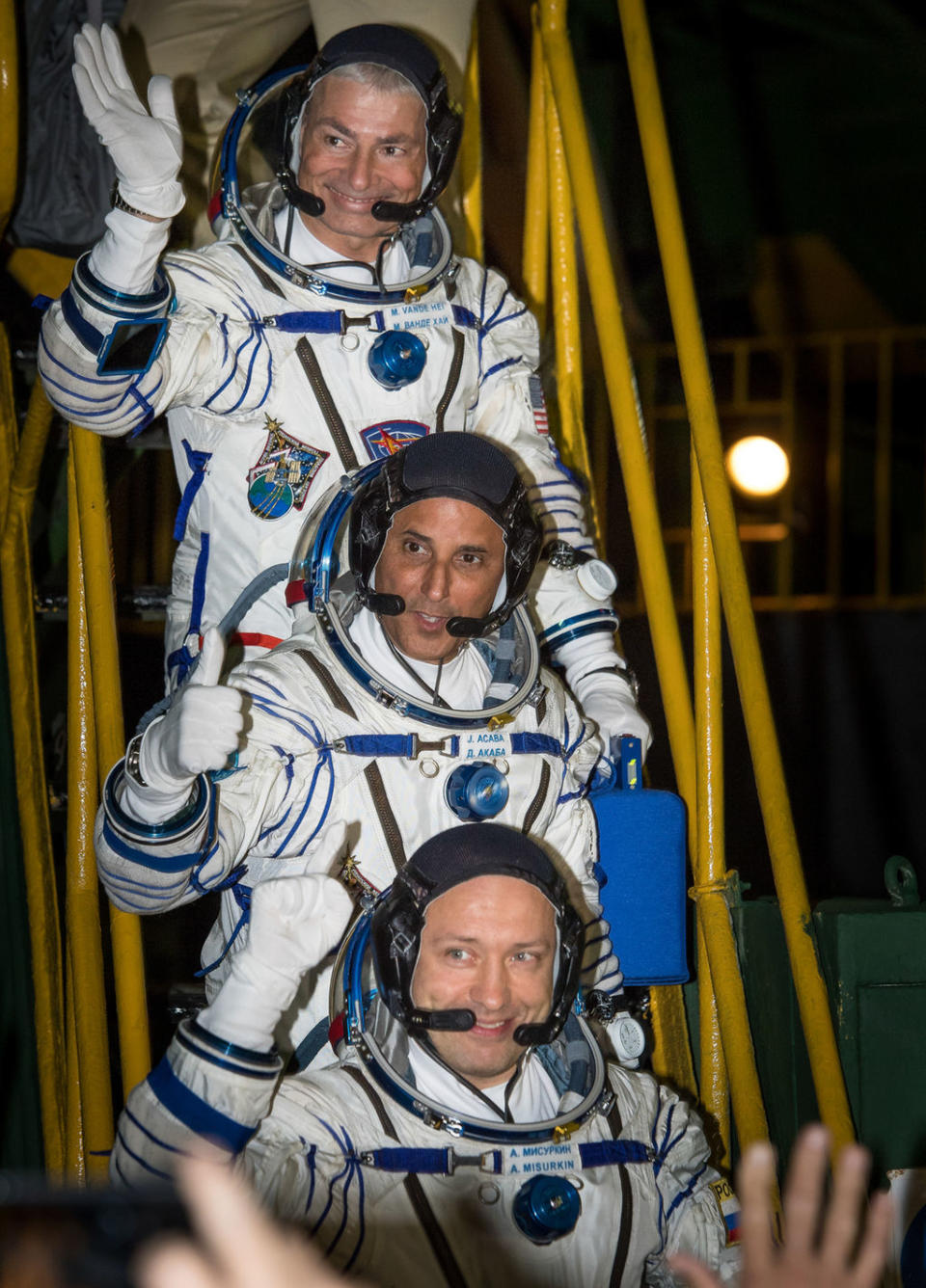 Expedition 53 flight engineers Mark Vande Hei (top) and Joe Acaba, and Soyuz Cmdr. Alexander Misurkin (bottom) wave farewell before boarding their Soyuz MS-06 spacecraft for launch from the Baikonur Cosmodrome in Kazakhstan on Wednesday (Sept. 13) <cite>NASA/Bill Ingalls</cite>