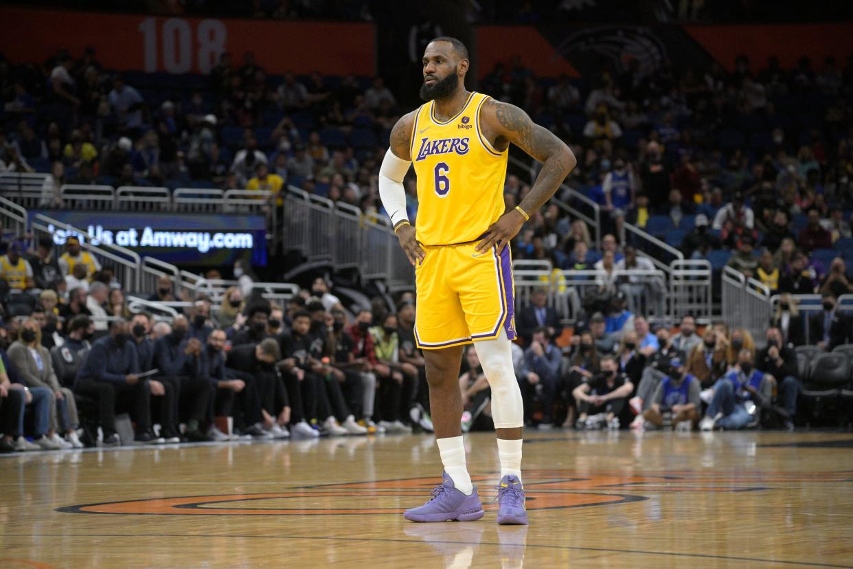 Los Angeles Lakers forward LeBron James (6) stands on the court during the first half of an NBA basketball game against the Orlando Magic, Friday, Jan. 21, 2022, in Orlando, Fla.