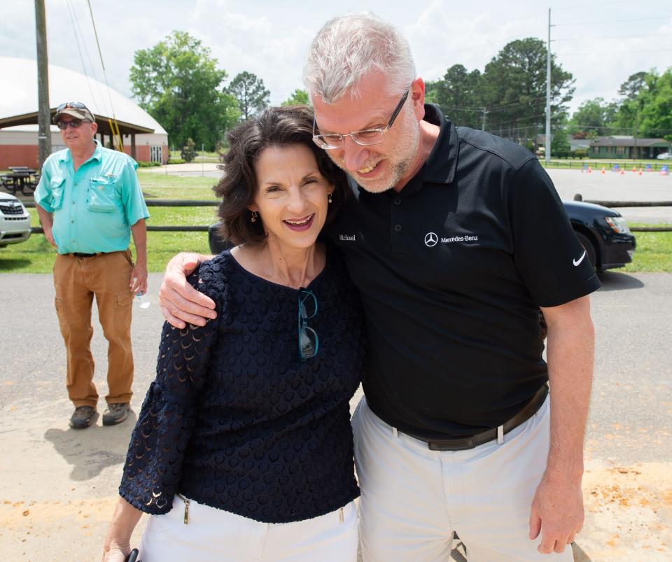 May 2, 2022; Tuscaloosa, AL, USA; Mercedes-Benz USI announced a partnership with Habitat for Humanity Tuscaloosa in their Operation Transformation initiative Monday outside a home under construction on Ash Street where Barbara Bonner will live. Habitat Executive Director hugs MBUSI President and CEO Michael Goebel at the build site. Mandatory Credit: Gary Cosby Jr.-The Tuscaloosa News
