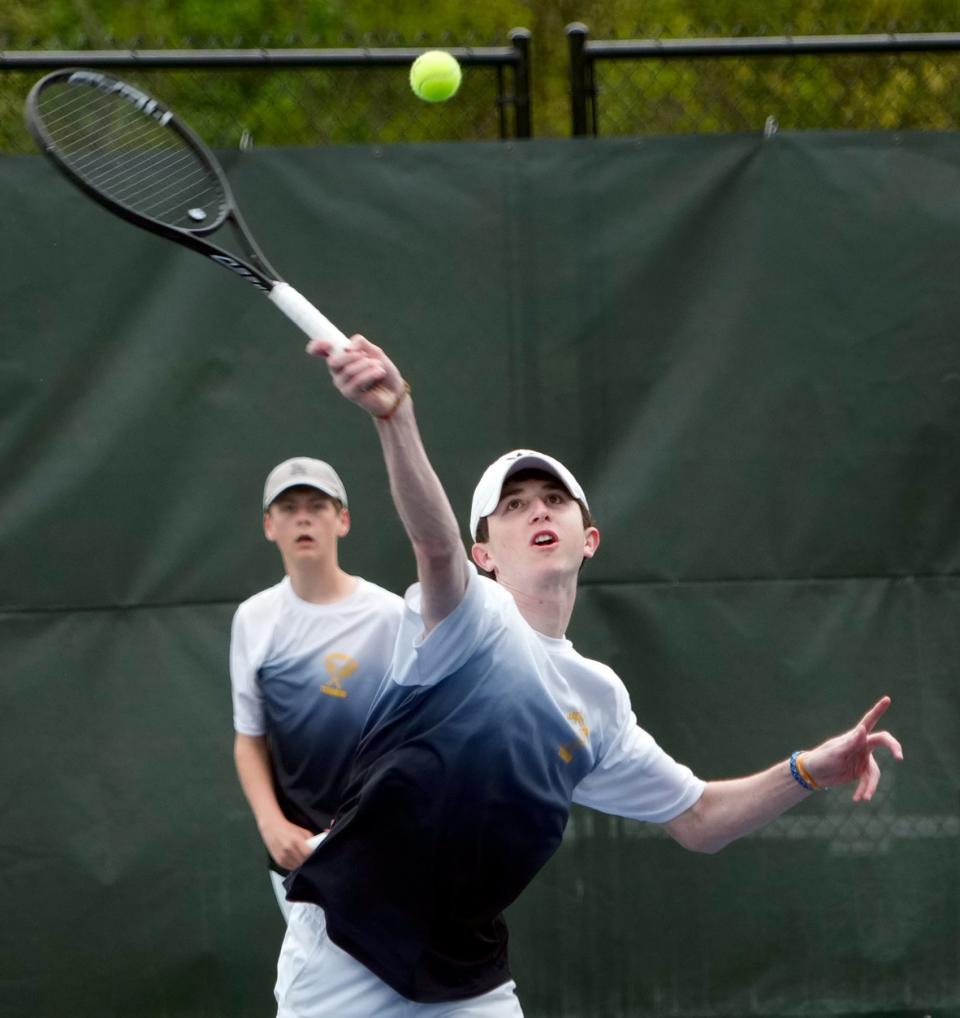 Bryce Kupperman hits a return as doubles partner Gabe Anderson watches during their championship match at Slater Park on Sunday.