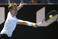 Sebastian Korda of the U.S. plays a backhand return to Cameron Norrie of Britain during their first round match at the Australian Open tennis championships in Melbourne, Australia, Monday, Jan. 17, 2022. (AP Photo/Andrew Brownbill)