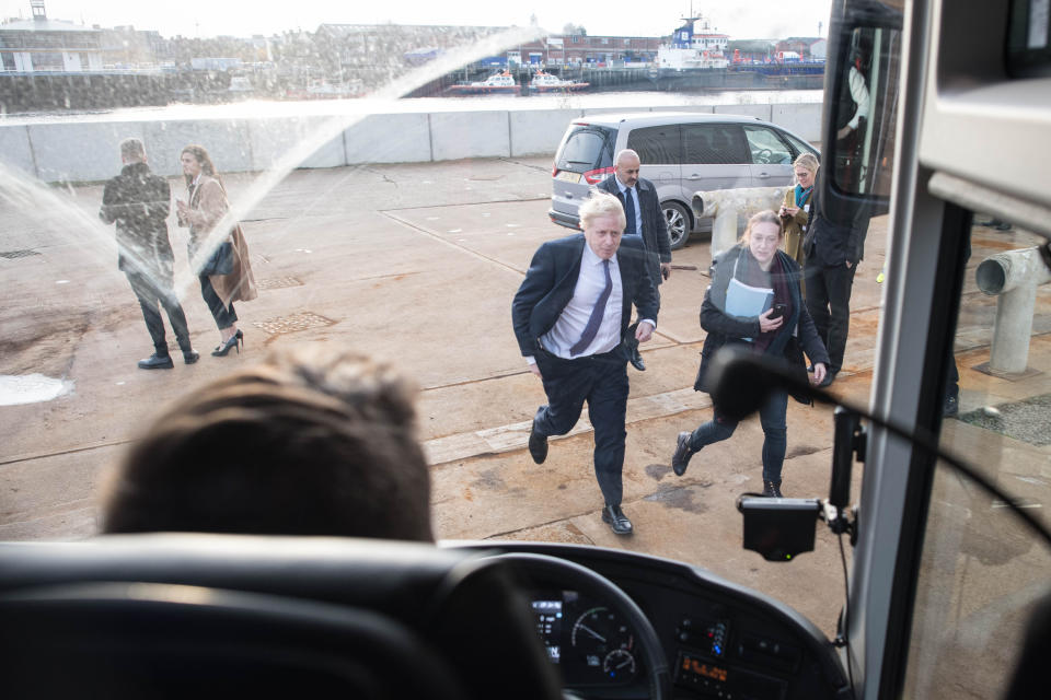 Prime Minister Boris Johnson makes his way back onto his battle bus after visiting Wilton Engineering Services in Middlesbrough while on the campaign trail for the General Election.