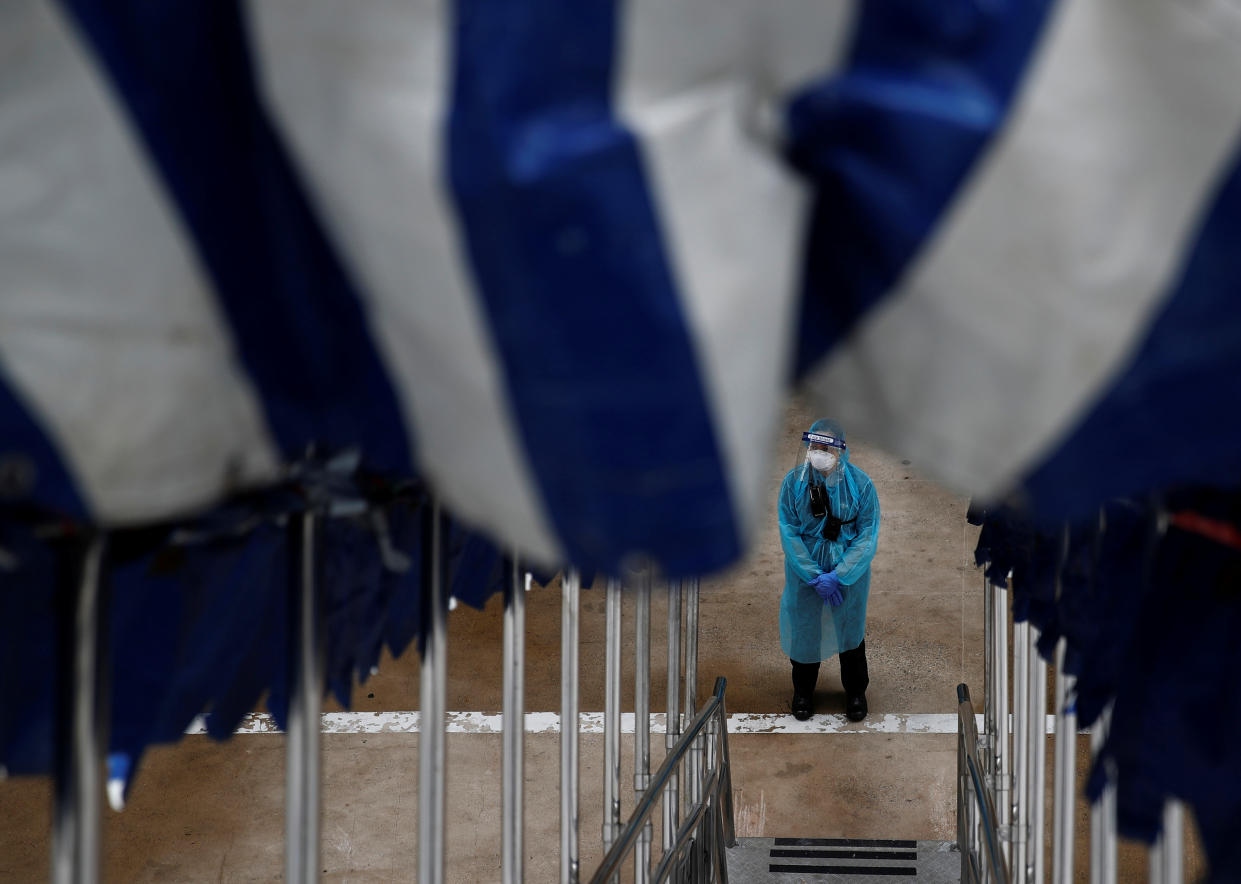 A security officer in personal protection equipment stands guard outside the SuperStar Gemini cruise ship, which is being used as a temporary accommodation facility for migrant workers who had recovered from COVID-19 here, on 23 May, 2020. (PHOTO: Reuters)