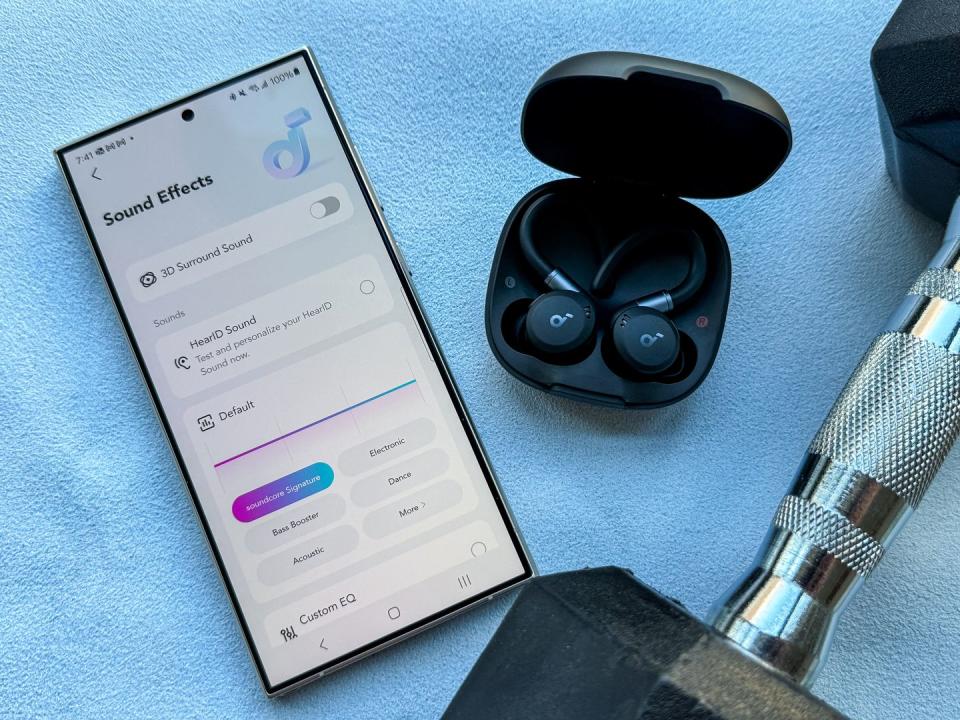 soundcore sport x20 wireless earbuds next to a phone with the soundcore app