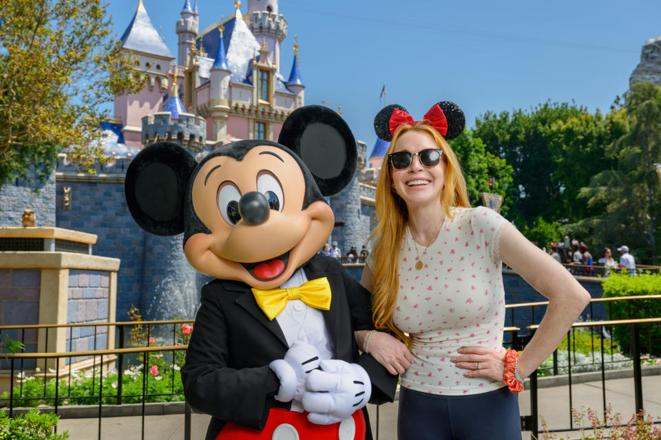 Lindsay Lohan poses with Mickey Mouse at Disney