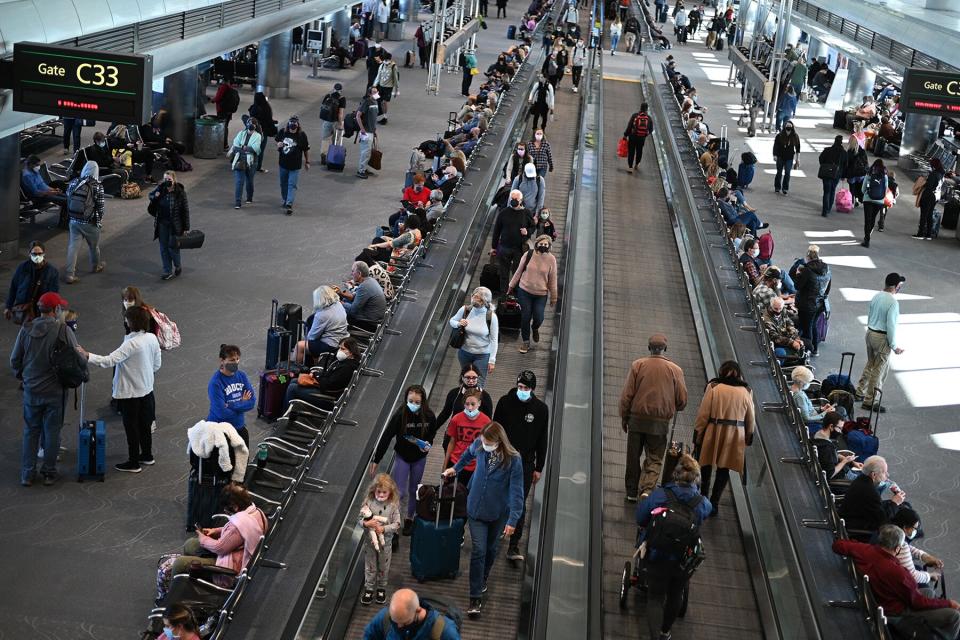 Travelers wear protective face masks at Denver International Airport