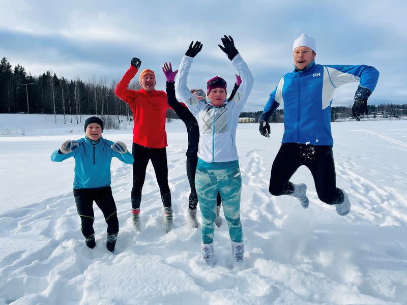 Athletes jump in the snow as they wear woollen socks instead of footwear during their training in Espoo