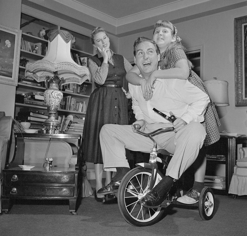 <p>Comedic actor Sid Caesar shows his silly side at home with his wife, Florence Levy, and their daughter. He's best known for hosting the TV programs <em>Your Show of Shows</em> and <em>Caesar's Hour.</em></p>