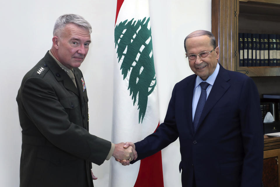 In this photo released the Lebanese Presidency press office, Lebanese president Michel Aoun, right, shakes hands with Gen. Frank McKenzie, the head of US Central Command, at the presidential palace, in Baabda, east of Beirut, Lebanon, Wednesday, July 8, 2020. McKenzie is in Lebanon for one day visit to meet with senior Lebanese political and defense leaders, including representatives of the Ministry of Defense and the Lebanese Armed Forces. (Lebanese Presidency press office via AP)