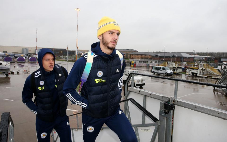 James Maddison of Leicester City and Harvey Barnes of Leicester City boards the plane as the Leicester City squad - Getty Images