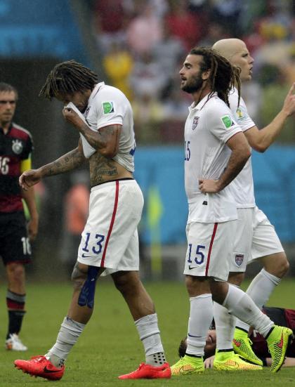 United States&#39; Jermaine Jones (13), Kyle Beckerman (15) and Michael Bradley, far right, walk over the pitch during the group G World Cup soccer match between the USA and Germany at the Arena Pernambuco in Recife, Brazil, Thursday, June 26, 2014. (AP Photo/Petr David Josek)