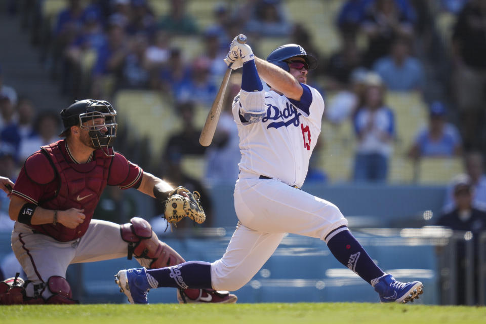 Los Angeles Dodgers' Max Muncy (13) hits a home run during the ninth inning of a baseball game against the Arizona Diamondbacks Sunday, July 11, 2021, in Los Angeles. Zach Reks and Mookie Betts also scored. The homer won the game for the Dodgers 7-4. (AP Photo/Ashley Landis)