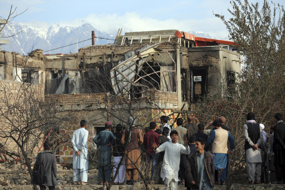 Afghan residents view a damaged home after oil tankers and trucks caught fire n Kabul, Afghanistan, Sunday, May 2, 2021. A fire roared through several fuel tankers on the northern edge of the Afghan capital late Saturday, injuring at least 10 people and plunging much of the city into darkness, officials said. (AP Photo/Rahmat Gul)