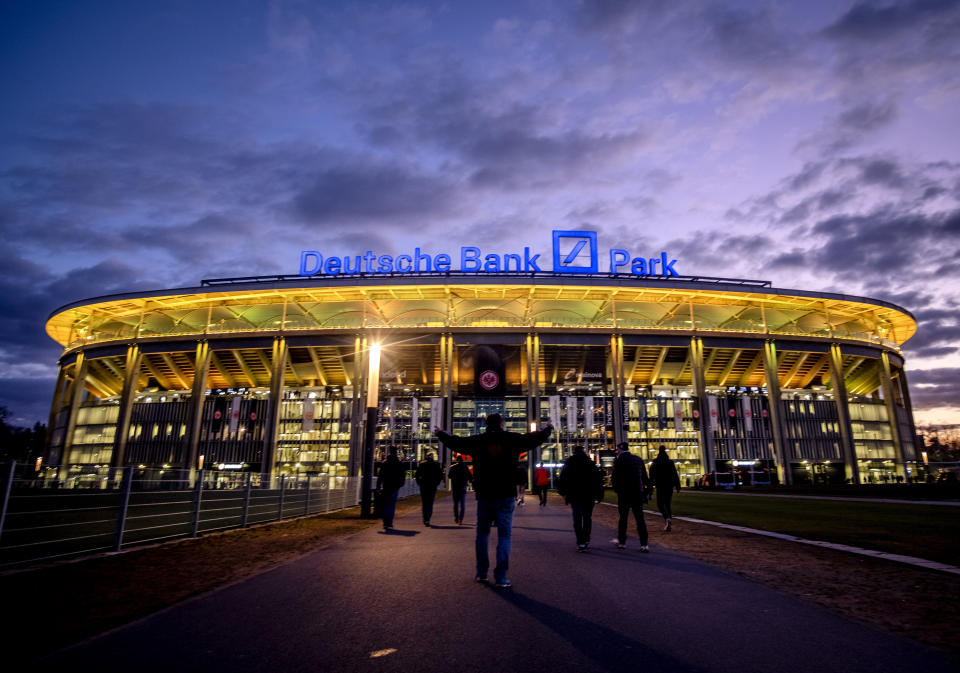 FILE - The Deutsche Bank Park is illuminated on occasion of the invasion in the Ukraine prior to a German Bundesliga soccer match between Eintracht Frankfurt and Bayern Munich in Frankfurt, Germany, Saturday, Feb. 26, 2022. The NFL says there are millions of German fans who are looking for a team to support. The Chiefs go first — they’ll play the Miami Dolphins on Sunday. A week later, the Patriots face the Indianapolis Colts. Both games are at Deutsche Bank Park. (AP Photo/Michael Probst, File)