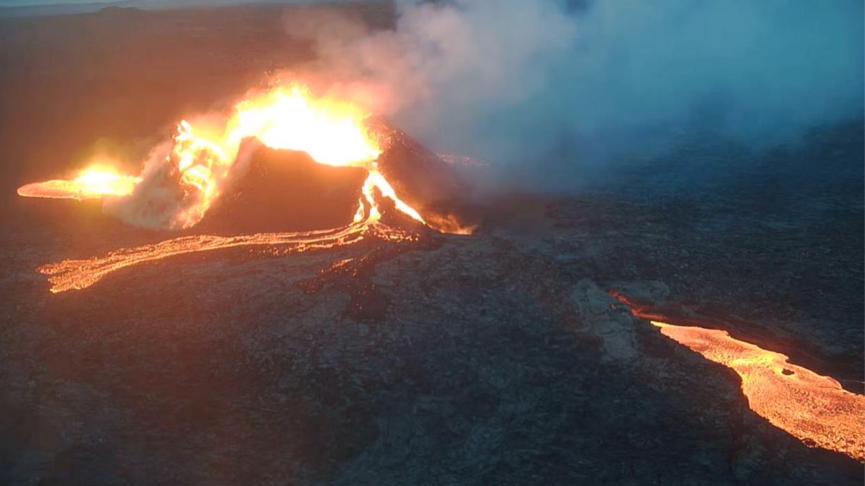  A volcano pouring lava into the surrounding area 