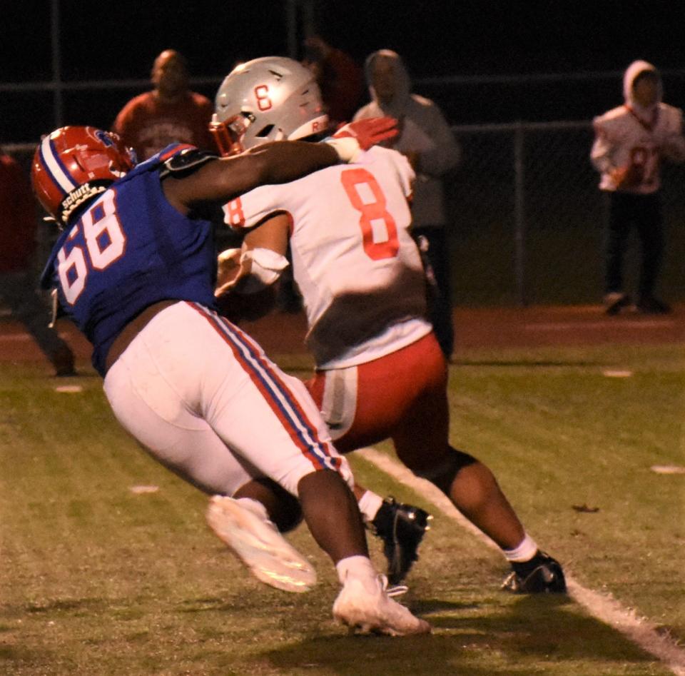 New Hartford Spartan Wilkenson Joseph (68) tackles Carthage ball-carrier Geremiah Ademola-Sadipe Friday.