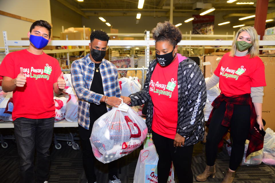 Mo Adams of Atlanta United FC (second from left) appeared at a drive-through event at an Atlanta Burlington Coat Factory, where he cleared $12,000 worth of layaway balances. (Photo: Pay Away the Layway)