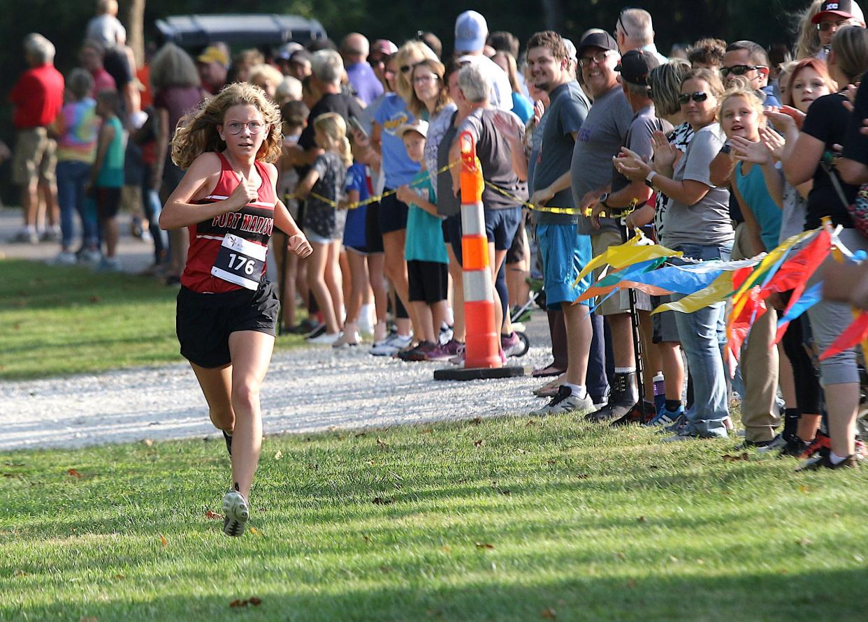 Fort Madison’s Avery Rump (176) runs to the finish line in the Fort Madison Invitational Thursday at Rodeo Park in Fort Madison. She won her class.