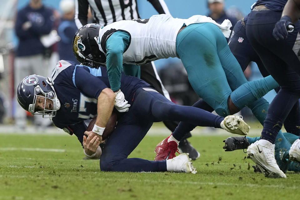 Jacksonville Jaguars linebacker Josh Allen, top, sacks Tennessee Titans quarterback Ryan Tannehill during the second half of an NFL football game Sunday, Dec. 11, 2022, in Nashville, Tenn. (AP Photo/Chris Carlson)