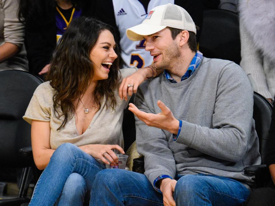 Mila Kunis (L) and Ashton Kutcher attend a basketball game between the Oklahoma City Thunder and the Los Angeles Lakers at Staples Center on December 19, 2014 in Los Angeles, California