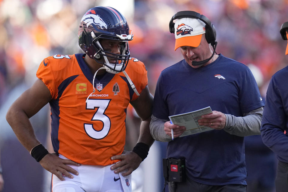 Denver Broncos quarterback Russell Wilson (3) talks with head coach Nathaniel Hackett during the second half of an NFL football game against the Houston Texans, Sunday, Sept. 18, 2022, in Denver. (AP Photo/Jack Dempsey)