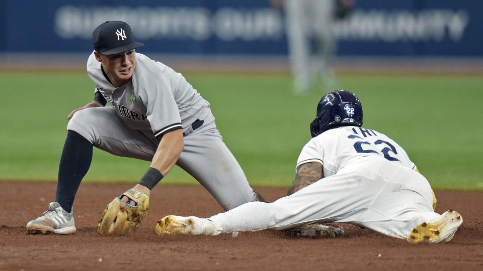 Tampa Bay Rays' Jose Siri (22) steals second base ahead of the tag by New York Yankees shortstop Anthony Volpe during the sixth inning of a baseball game Saturday, May 6, 2023, in St. Petersburg, Fla. (AP Photo/Chris O'Meara)