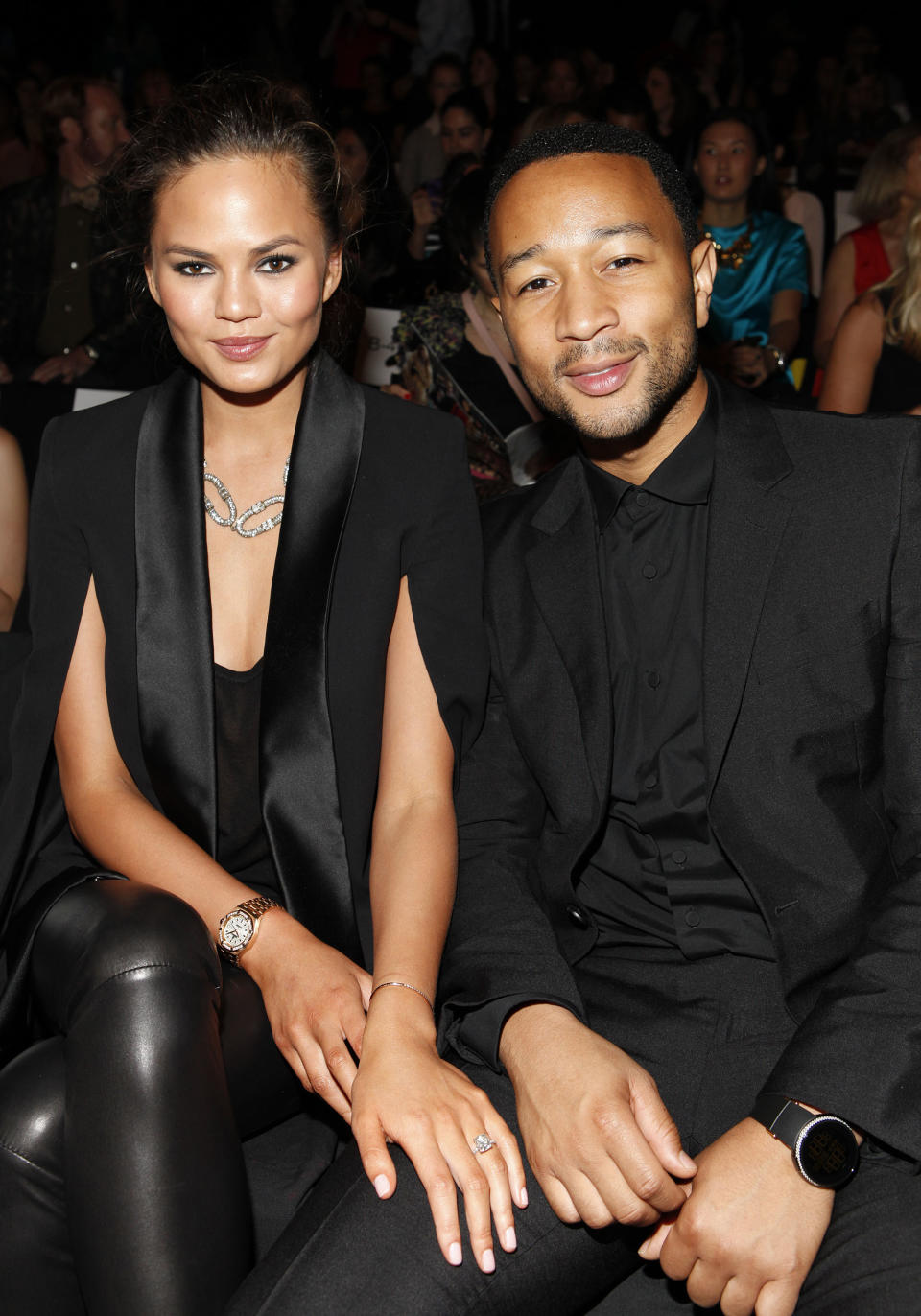 Chrissy Teigen, left, and John Legend attend the Badgley Mischka Spring 2014 collection on Tuesday, Sept. 10, 2013, during Mercedes-Benz Fashion Week in New York. (Photo by Amy Sussman/Invision/AP)
