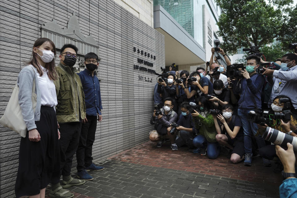 Hong Kong activists, from right, Joshua Wong, Ivan Lam and Agnes Chow arrive at a court in Hong Kong, Monday, Nov. 22. 2020. The trio appears at court for their trial as they face charges related to the besieging of a police station during anti-government protests last year. (AP Photo/Vincent Yu)