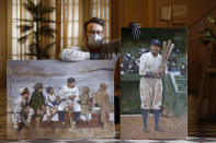 In this Wednesday, April 29, 2020, photo, Brooklyn-based baseball artist Graig Kreindler poses with two of his paintings of Babe Ruth, both unfinished, in the lobby of his residence in New York. Over 200 of Kreindler's paintings form the bulk of the exhibit "Black Baseball in Living Color:The Art of Graig Kreindler," at the Negro Leagues Baseball Museum in Kansas City, Mo. The museum is closed now, but expects to reopen early in June. Both paintings of Ruth are based on photographs. (AP Photo/Kathy Willens)