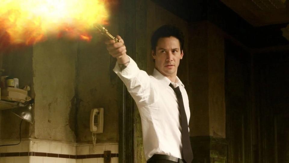 Keanu Reeves holds out a light as Constantine.