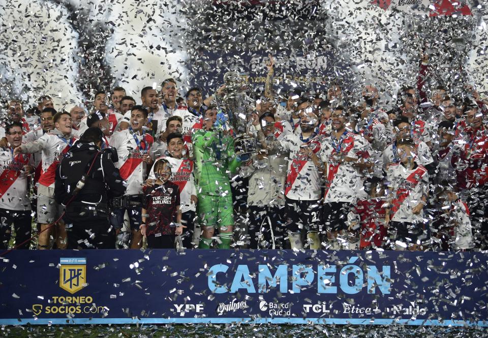 Argentina's River Plate players hold their trophy and celebrate winning the local soccer tournament at Monumental stadium in Buenos Aires, Argentina Thursday, Nov. 25, 2021. River defeated Racing 4-0 and became the tournament champions. (AP Photo/Gustavo Garello)