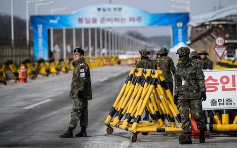 South Korean soldiers patrol the road connecting South and North Korea at the Unification Bridge near the Demilitarized Zone (DMZ) on February 7